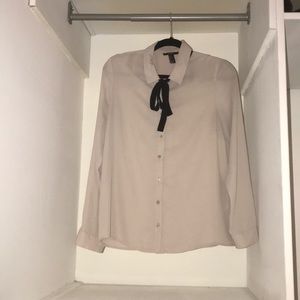 Cream colored long sleeve blouse with neck tie